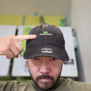 Toshio wearing a Sad Francisco dad hat.