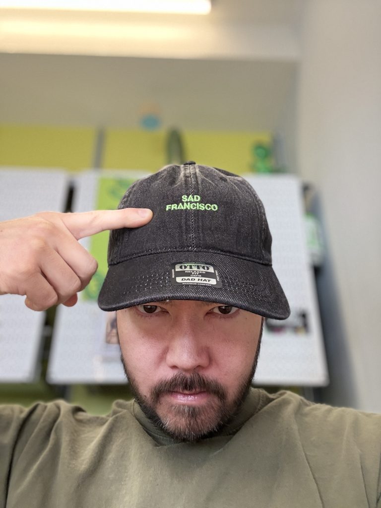 Toshio wearing a Sad Francisco dad hat.